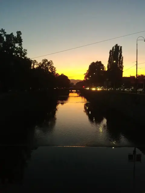 Sunset view of the Miljacka River in the heart of Sarajevo.