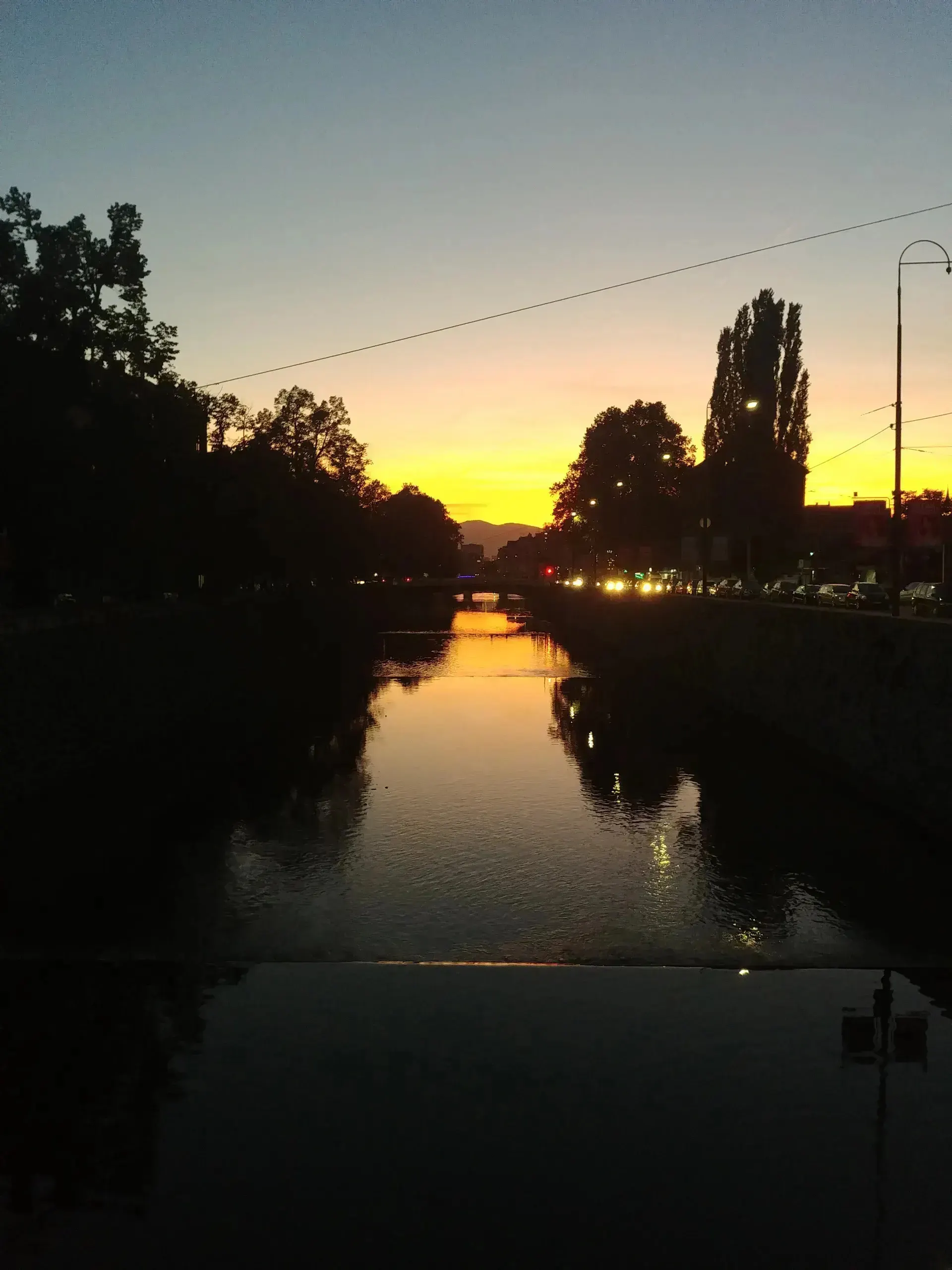 Sunset view of the Miljacka River in the heart of Sarajevo.